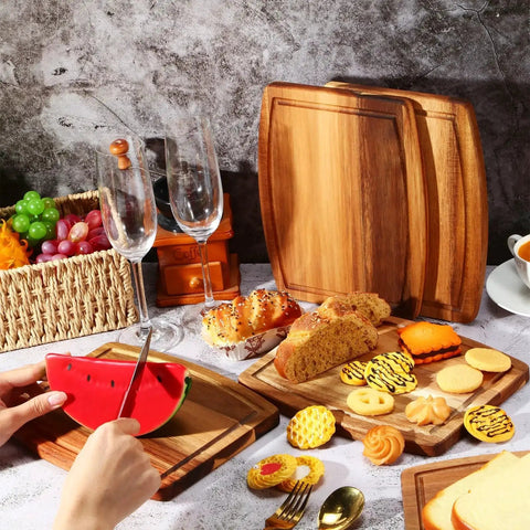 Acacia Wood Cutting Boards Set 10 Pcs Bulk for Laser Engraving and Charcuterie Serving Grooved Chopping Boards for Cheese Bread Fruit 8x10 Inches Party Ready Gift Worthy Holiday Housewarming displayed with food and glasses.