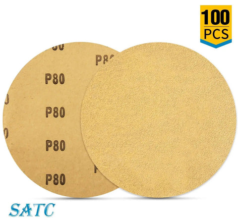 Two 6 inch 80 grit adhesive backed sanding discs aluminum oxide for drill, one showing grit side, the other backing, 100 pack.