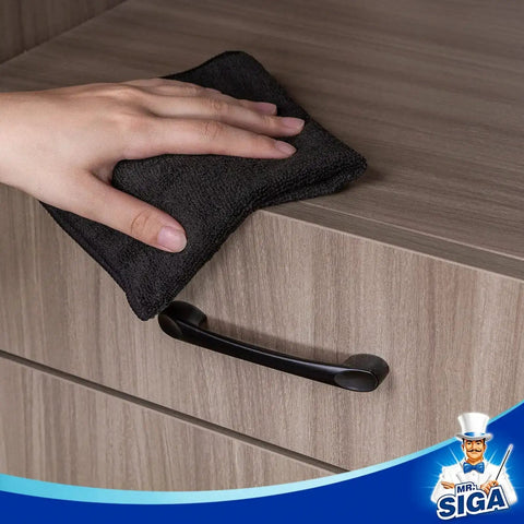 Hand using All Purpose Microfiber Cleaning Cloths Pack Of 12, Ultra Soft, Killer Streak Free And Scratch Free Rags on wooden surface