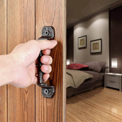 Hand using Sliding Barn Door Handles Set Of 4 In Dark Brown Cast Iron With Vintage Rustic Finish on wooden door