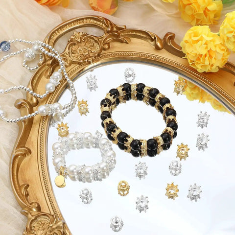 Reflection of 60 Pcs Crown Charms Set in Gold and Silver for DIY Jewelry Making Crafts on ornate tray with bracelets