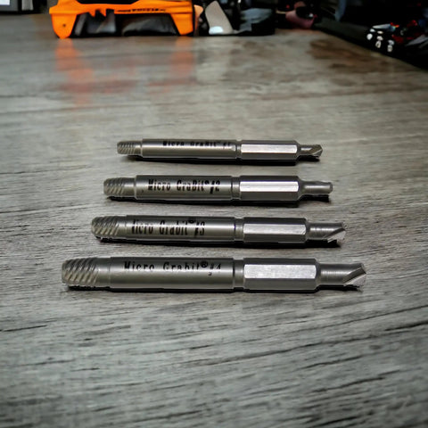 Close-up of Grabit Micro 4 Piece Bolt And Screw Extractor Kit For Tiny Stripped Fasteners Ideal For PC Mac Electronics And Precision Repairs Pentalobe Compatible For Apple Devices And RC Models Made In The USA Alden on table