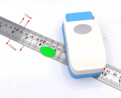 Oval Scrapbooking Punch For Paper Crafting One Inch 25mm Lever Embossing Punch next to ruler showing size measurement