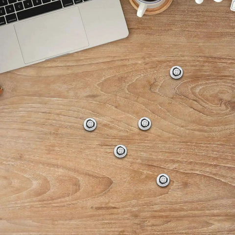 10 Piece M3 Black Hard Drive Mounting Screws Set For Laptop And Desktop Computers on wooden desk with laptop nearby