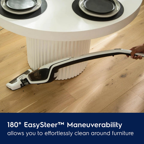 Electrolux Ergorapido cordless 2-in-1 vacuum cleaner in satin white used on wood floor under a round white table
