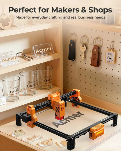 Ultra Powerful 7000mW Laser Engraver And Cutter With 300 By 300 Mm Working Area Delivers 0.01mm Precision For Wood Metal Acrylic Leather And DIY Projects Ideal For Education And Pro Makers ACMER on a workshop desk, surrounded by engraved items.