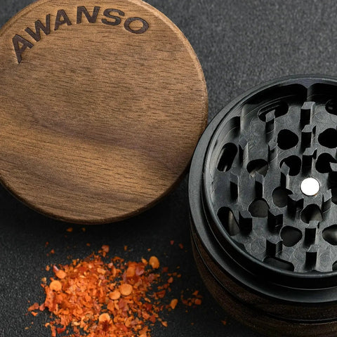 Open top view of Walnut Wood 2.5 Inch 3 Piece Spice Grinder With Aluminum Chamber Magnetic Lid showing grinder teeth and spices