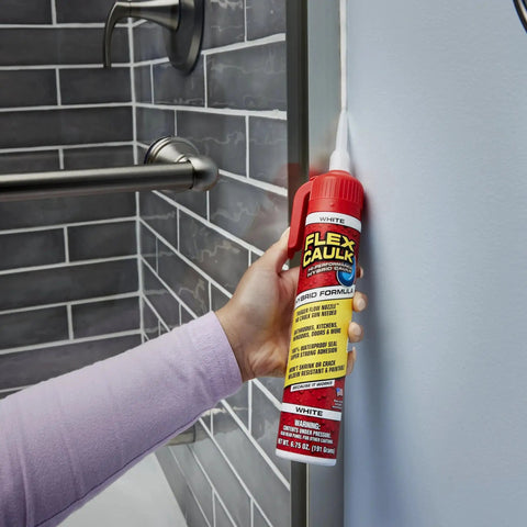 Person using Waterproof Hybrid Caulk Sealant Paintable Indoor Outdoor No Caulk Gun Needed on bathroom tile joint