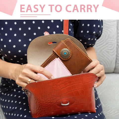 Person placing 10 Pack Soft Microfiber Glasses Cleaning Cloths for Eyeglasses Cameras Phones into a red leather purse.