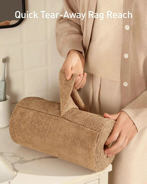 Person holding Tear-Away Microfiber Cleaning Cloth Roll 12-Inch Reusable 75 Pack on a bathroom counter.