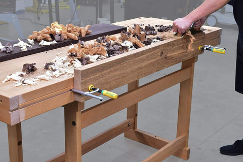 Woodworker using Matchfit Dovetail Clamps Four Pack Exclusive Bundle With Dovetail Router Bit One Quarter Inch Shank on workbench
