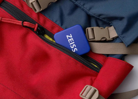 ZEISS Lens Cleaning Wipes Tin Box with Hinged Lid in backpack pocket for easy lens care on-the-go