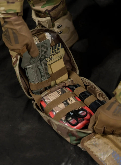 Open Tactical IFAK Trauma Kit with CAT Tourniquet for Wound Care in Durable MOLLE Pouch with medical supplies visible, Black Rhino Rescue Gear.