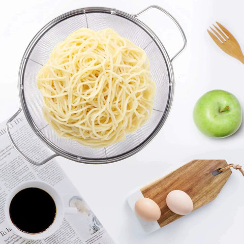 Top view of three pack 18/8 stainless steel colander sieves set with pasta, handy handles, and resting base for straining or rinsing.