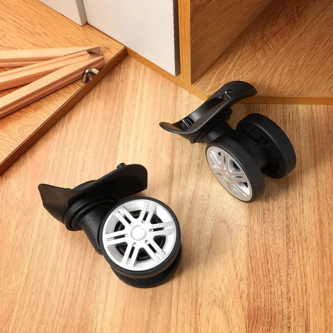 4 Pcs Universal Suitcase Wheel Replacement Set Heavy Duty Luggage Casters Quiet Dual Row Design Black on wooden surface