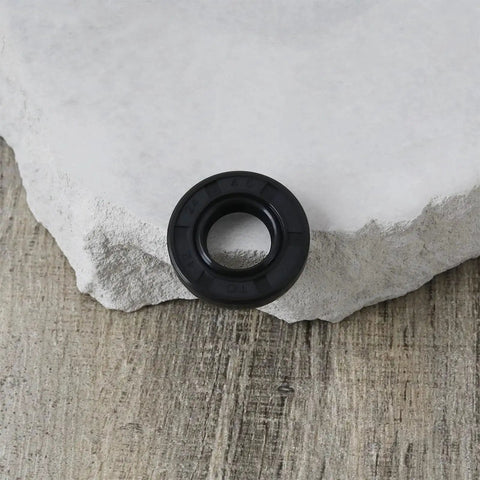 Six Pack TC Oil Seal Nitrile Rotary Shaft Seal Double Lip 12x24x4.5mm for industrial equipment, close-up view on stone surface.