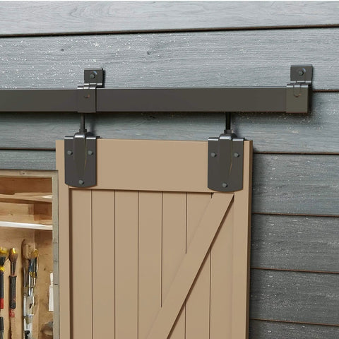 12 Ft Box Rail Exterior Barn Door Hardware Kit For Two Doors Built Tough Heavy Duty Sliding Track System Wall Mount Kit Doors Not Included Supports Up To 450 Lbs Fits One And Three Eighths Inch To One And Three Quarters Inch Thick Panels Black installed on wood frame.