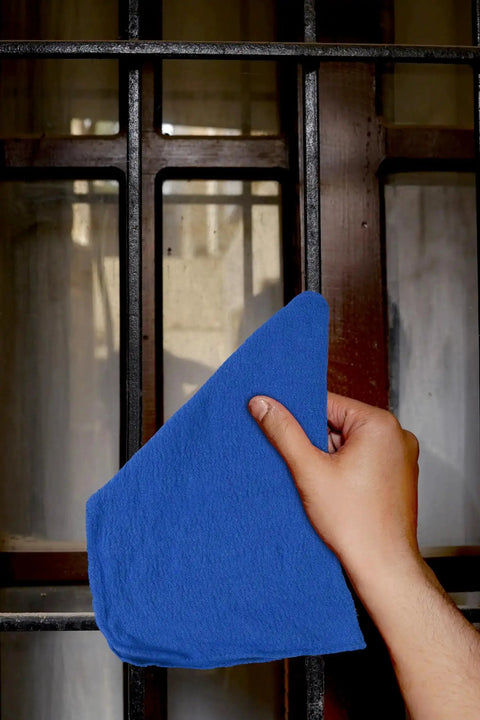 Hand cleaning window with blue Ultra Absorbent Cotton Shop Towels Pack Of 50 12 By 14 Inches Super Soft Rags For Home Garage And Auto Care Grime Busting Multipurpose Cleaning Towels For Industrial Use.
