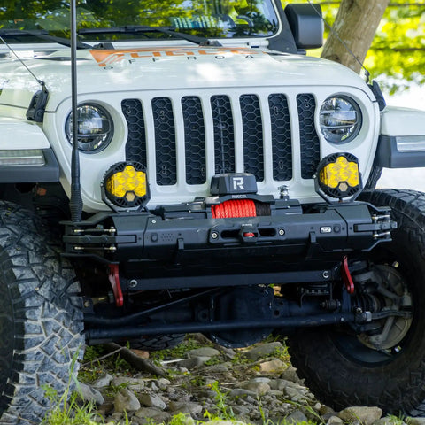 Beast Heavy Duty 13500lb Waterproof Electric Winch With Synthetic Rope For Trucks And SUVs, 12V System, Hawse Fairlead, 2 In 1 Infrared Remote And Wired Control, Red Rope RUGCEL installed on a Jeep's front bumper.