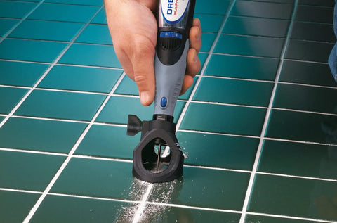 Grout Removal Rotary Tool Attachment For Tile Grout Lines With A 30 Degree Cutting Angle Centered Guides Large Visibility Window in use on tile floor.