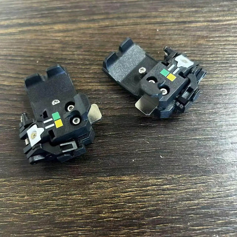 SP-03 Original Fiber Holder Chucking Jig for Fusion Splicer Clamps on wooden surface, compatible with FSM-90R FSM-88R FSM-90S FSM-88S