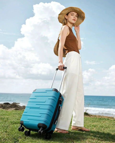 Woman using Lake Blue Three Piece Hardside Luggage Set by Coolife with TSA Lock and 360-degree spinner wheels on a beach