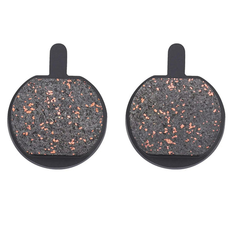 Pair of round bicycle disc brake pads with copper flecks, front view