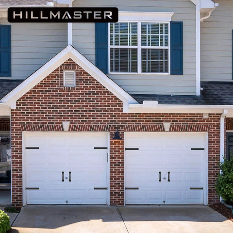 House with garage doors featuring Six Piece Garage Door Magnetic Decorative Hardware Kit with four rectangle hinge magnets and two handles in black.