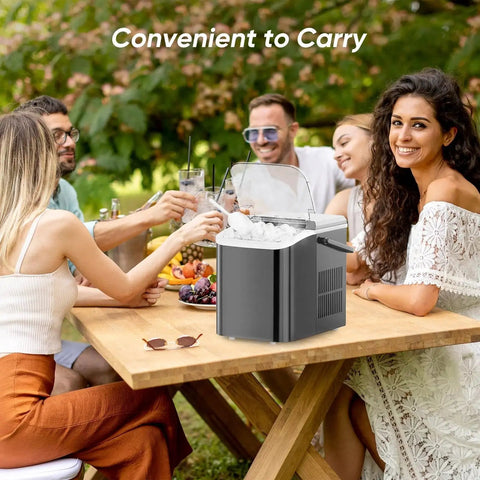 Portable Countertop Ice Maker With Handle 26 Lbs 24H 9 Bullet Ice In 6 Minutes on a picnic table with people outdoors