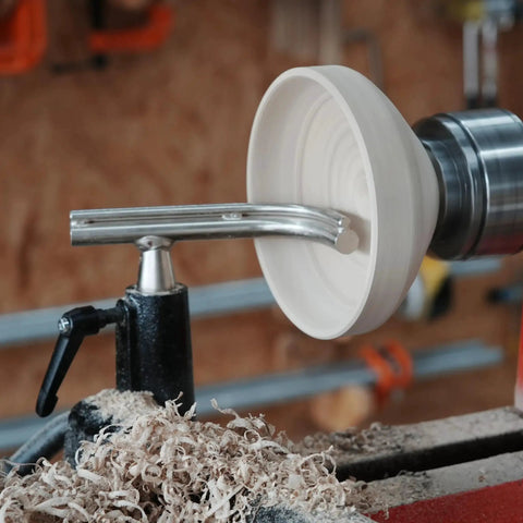 Four Piece Toolrest Set For Wood Lathe Bowl Turning With A One Inch Stem Glide For Deep Interior Access, Ergonomic Concave Design For Snug Finger Fit And All Day Turning Reach BMWOOD in use on a wood lathe with shavings.
