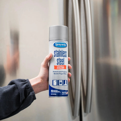 Sprayway stainless steel cleaner spray can, 15 oz, held by hand beside a stainless steel refrigerator