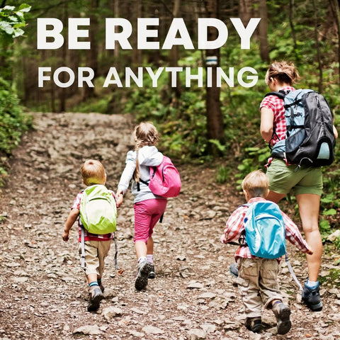 Family hiking with kids carrying backpacks, illustrating need for Travel First Aid Kit For Kids Designed By A Mom And A Nurse.