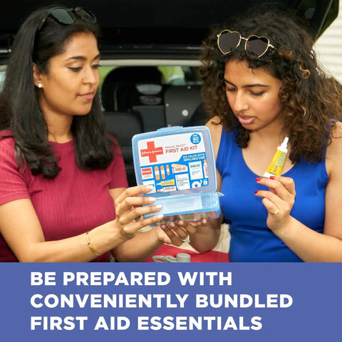 Two people using Travel Ready 80-Piece First Aid Kit For Home Car Travel Camping Essentials with BAND-AID supplies in open car trunk.