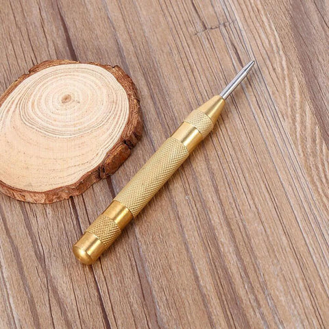 Automatic Center Punch Tool With HSS Tip Spring Loaded Brass Body No Hammer Needed For Precise Marking In Wood And Metal One Eighth Inch Roll Pin Punch Set Self Centering No Slip Durable Pro Grade Quality Ready To Roll on wooden surface.