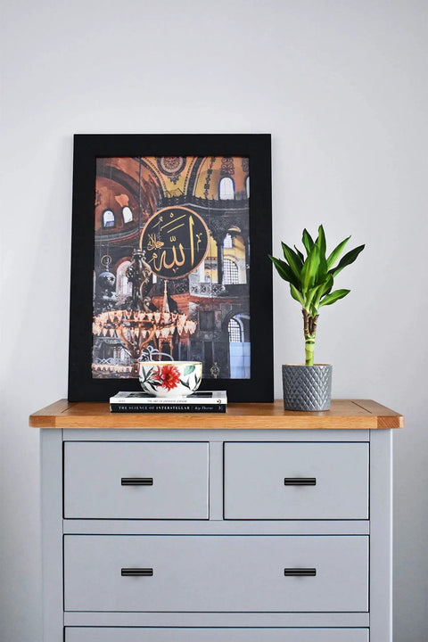 Grey chest of drawers with 10 Pack 2 Inch Matte Black Stainless Steel Cabinet Pulls, framed art, and potted plant on top