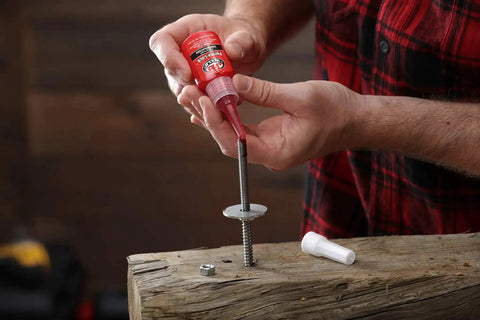 Person applying Perma Lock High Strength Threadlocker Red 36 Ml For Heavy Duty Bolts And Fasteners on a metal bolt