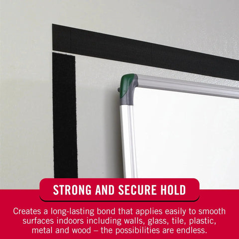 Black Adhesive Hook And Loop Tape Roll Five Feet By Three Quarters Inch Cut To Length Strips securing whiteboard on wall.