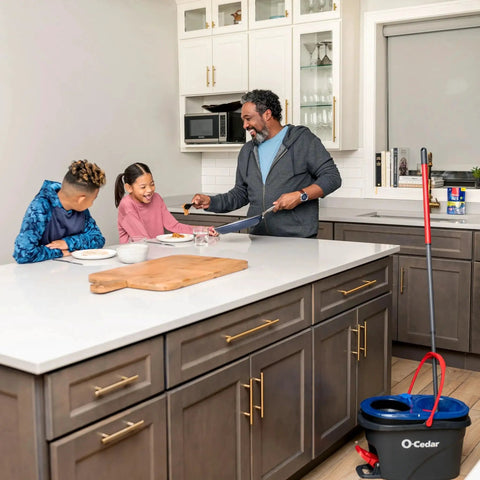 Family kitchen scene with RinseClean Spin Mop And Bucket System For Clean Water Mopping Lets You Clean With Clean Water From Start To Finish.