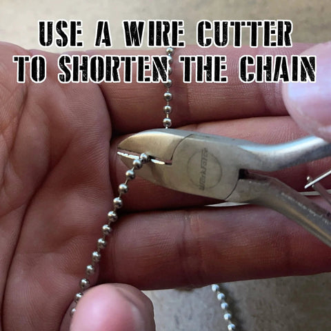 Hands cutting 24 Inch Ball Chain Necklace In T304 Stainless Steel Two Point Four Millimeter Gauge Made In The USA with wire cutter