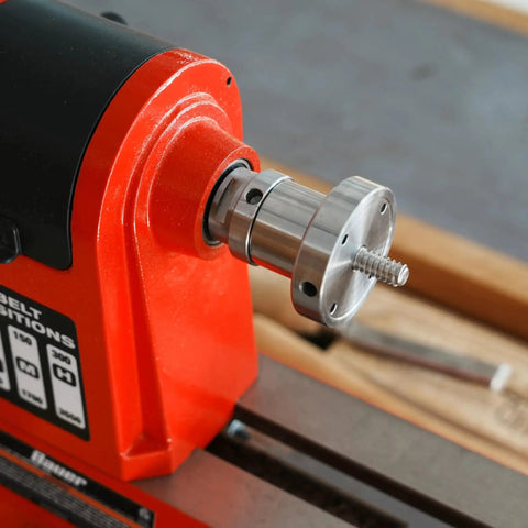 Woodturning Lathe Thread Adapter 1x8TPI Female To One And A Quarter Inch Eight TPI Male For Headstock Spindle With Jackscrews Safe Reverse Turning Built From High Quality Steel installed on a red lathe machine