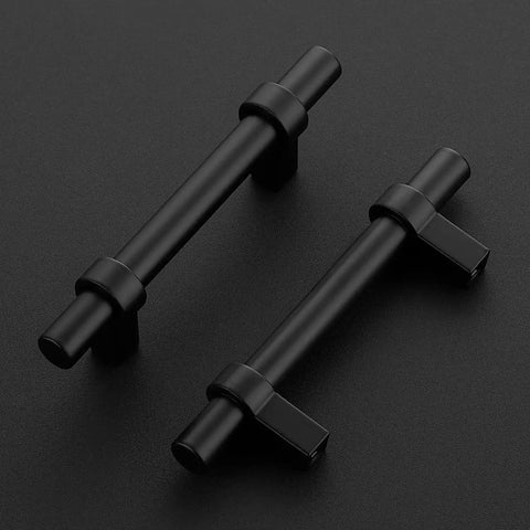 Two matte black cabinet pulls with square bases on a black surface, part of the 30 Pack Matte Black 5 Inch Cabinet Pulls With Square Base