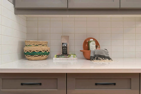 Kitchen countertop with decor and cabinets featuring 30 Pack Solid 5 Inch Cabinet Handles Matte Black Pulls For Kitchen Drawers And Cabinets.