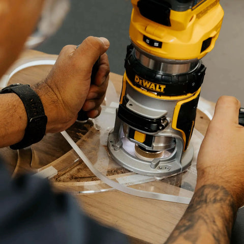 TrimFit Pro Dual Grip Router Base Plate For DeWalt DWP611 And DCW600B in use on wood surface, clear acrylic base seen