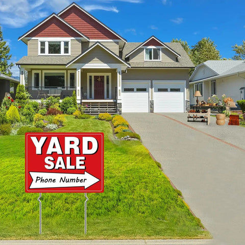 Yard sale sign with phone number displayed in front of a suburban house on a lawn, promoting a yard sale event at the location.