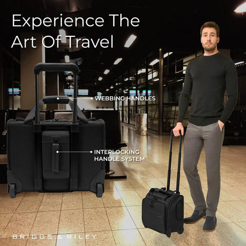 Man walking with Baseline Carry On Bag With Smooth Roll 2 Wheel Mobility Softside Luggage That Fits Overhead And Under Seats For Effortless Travel.
