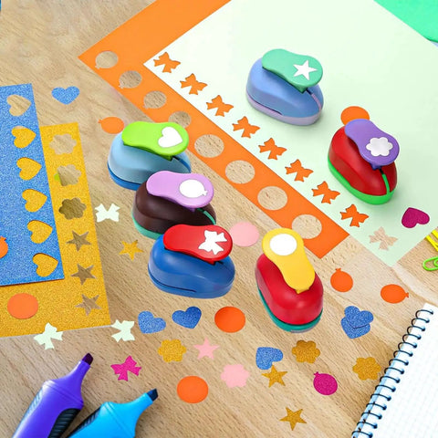 Six Shape Hole Punch Set For Kids 1 Inch Shape Punches on table with cardstock sheets for scrapbooking and DIY crafts