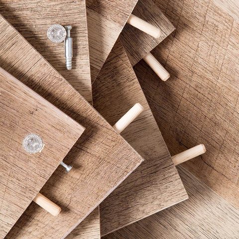 Wooden dowel pins set, 200 pcs, nine sizes with tapered beveled ends and fluted grooves, inserted in wooden boards for diy projects