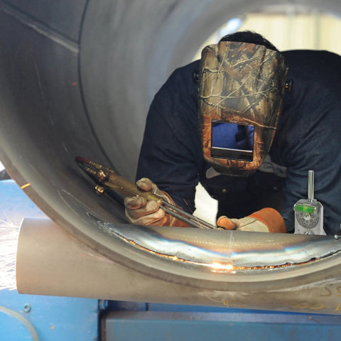 Welder using pipe marker centering tool for quick center lines and angles on pipes 0.5 inch and up with 4 inch Y type head Curv O Mark standard 6.