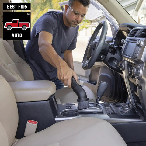 Man using Beast Tough Heavy Duty Wet Dry Vac Attachment Kit For One Seven Eighths Inch Hoses Pro Grade Shop Vacuum in car interior.