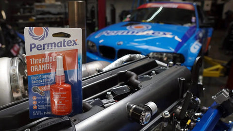 Orange Threadlocker For High Vibration Machinery Removable With Hand Tools Easy Disassembly 3X Stronger Than Blue Prevents Loosening And Backing Out In Auto And Motorcycle Apps 10 Ml Tube By Permatex package near blue race car